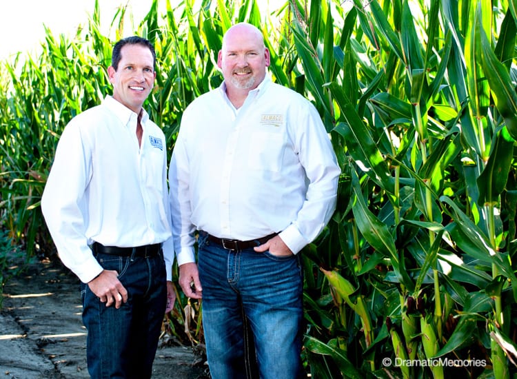 business owners standing near a corn field
